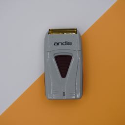 Andis TS-1 shaver on white and gold background