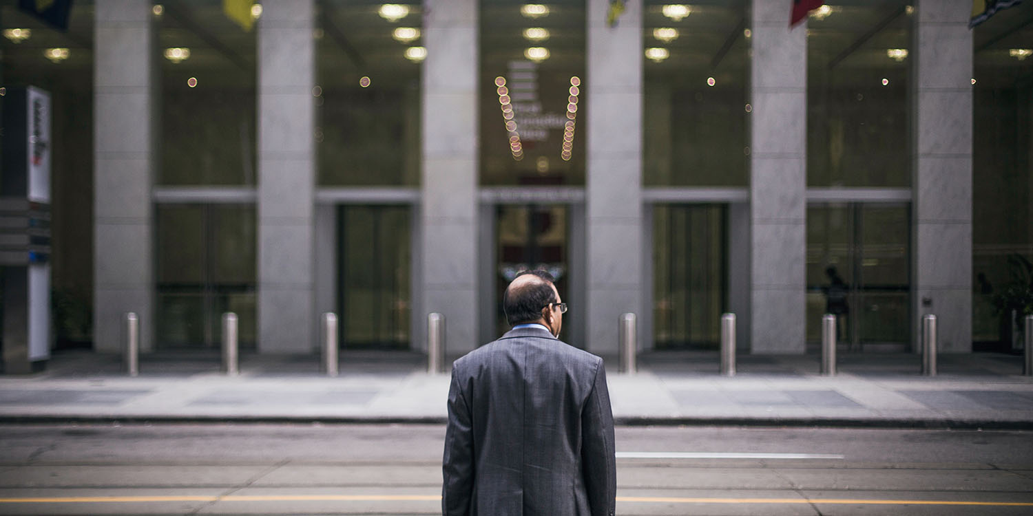 DOJ antitrust lawyers | Man crossing road into building